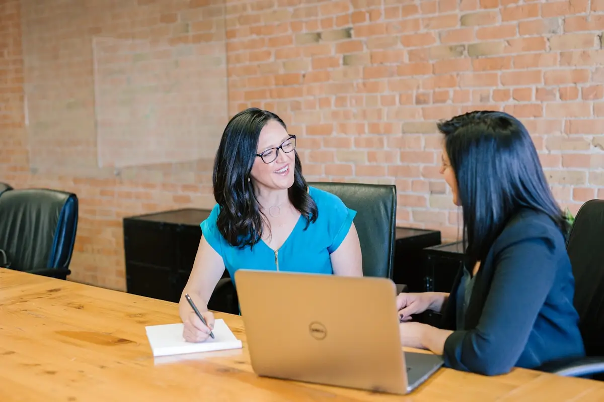 Two professionals signing a business associate agreement contract for HIPAA compliance