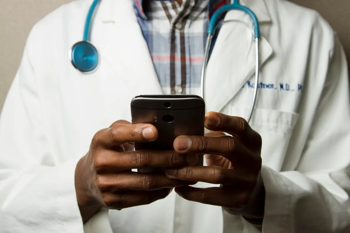 Healthcare professional using a mobile device to access electronic health records under HIPAA regulations